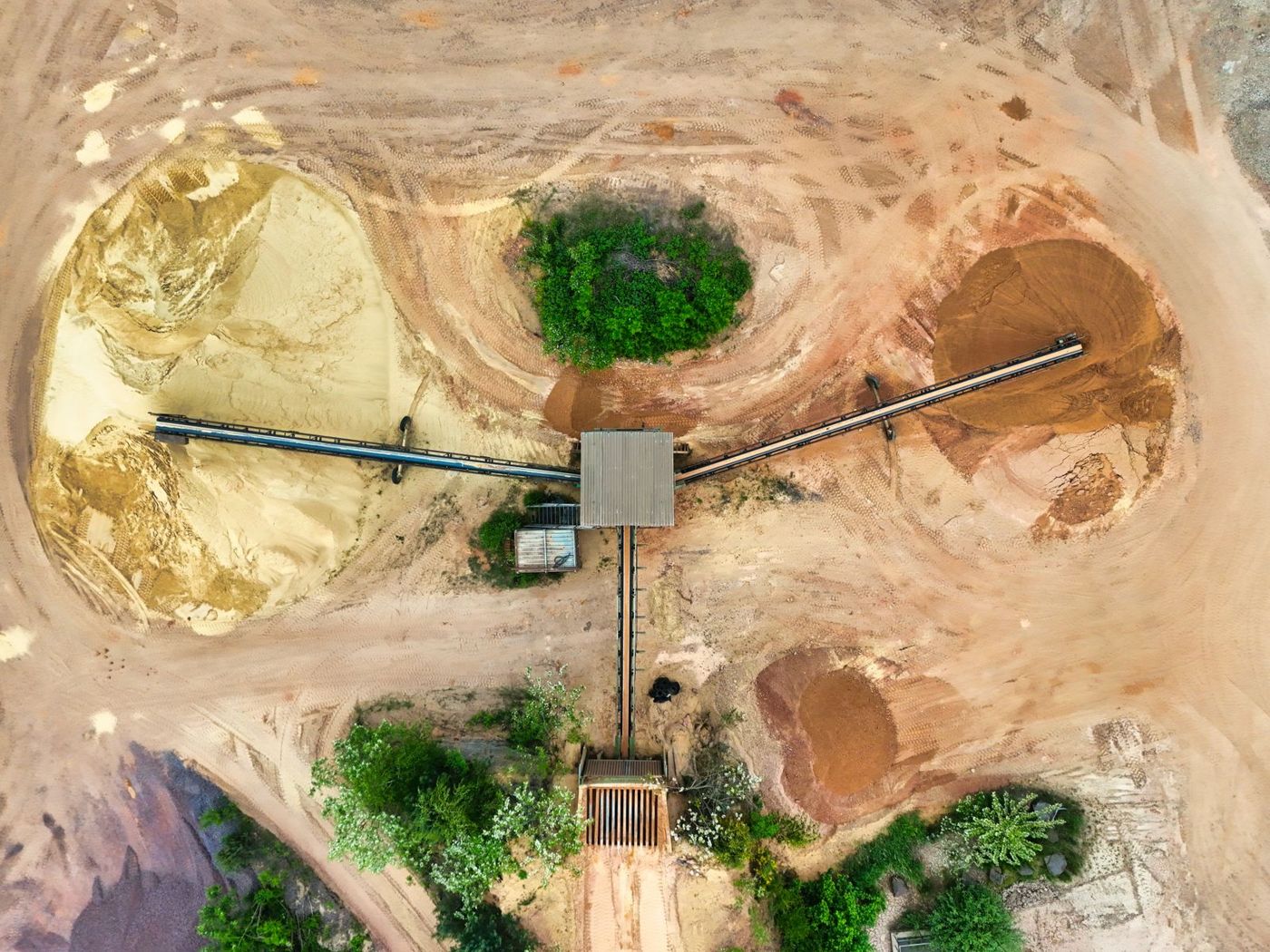 Aerial view of conveyors moving material between stockpiles at a quarry