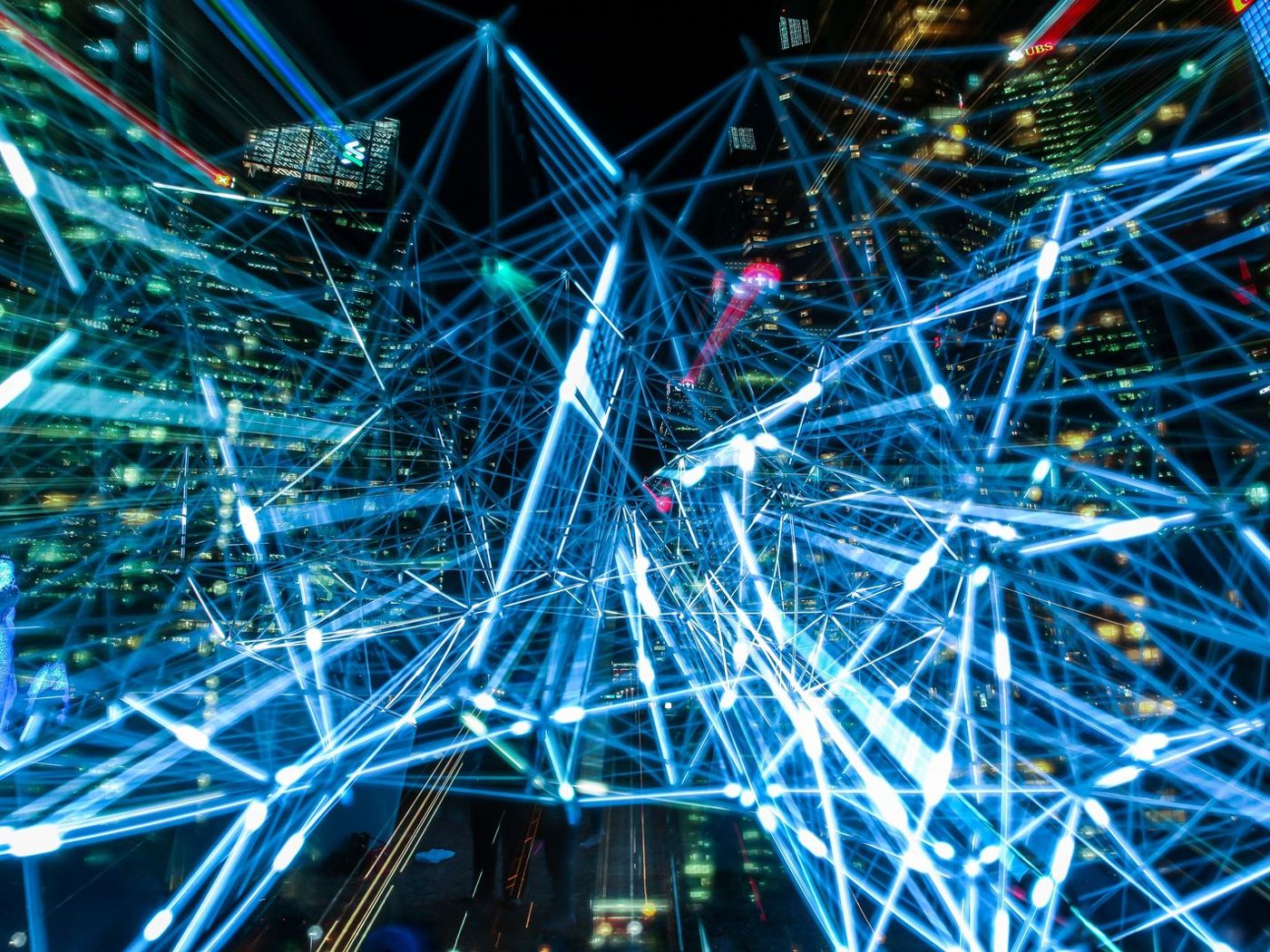 Glowing blue light trails crossing in a dense network
