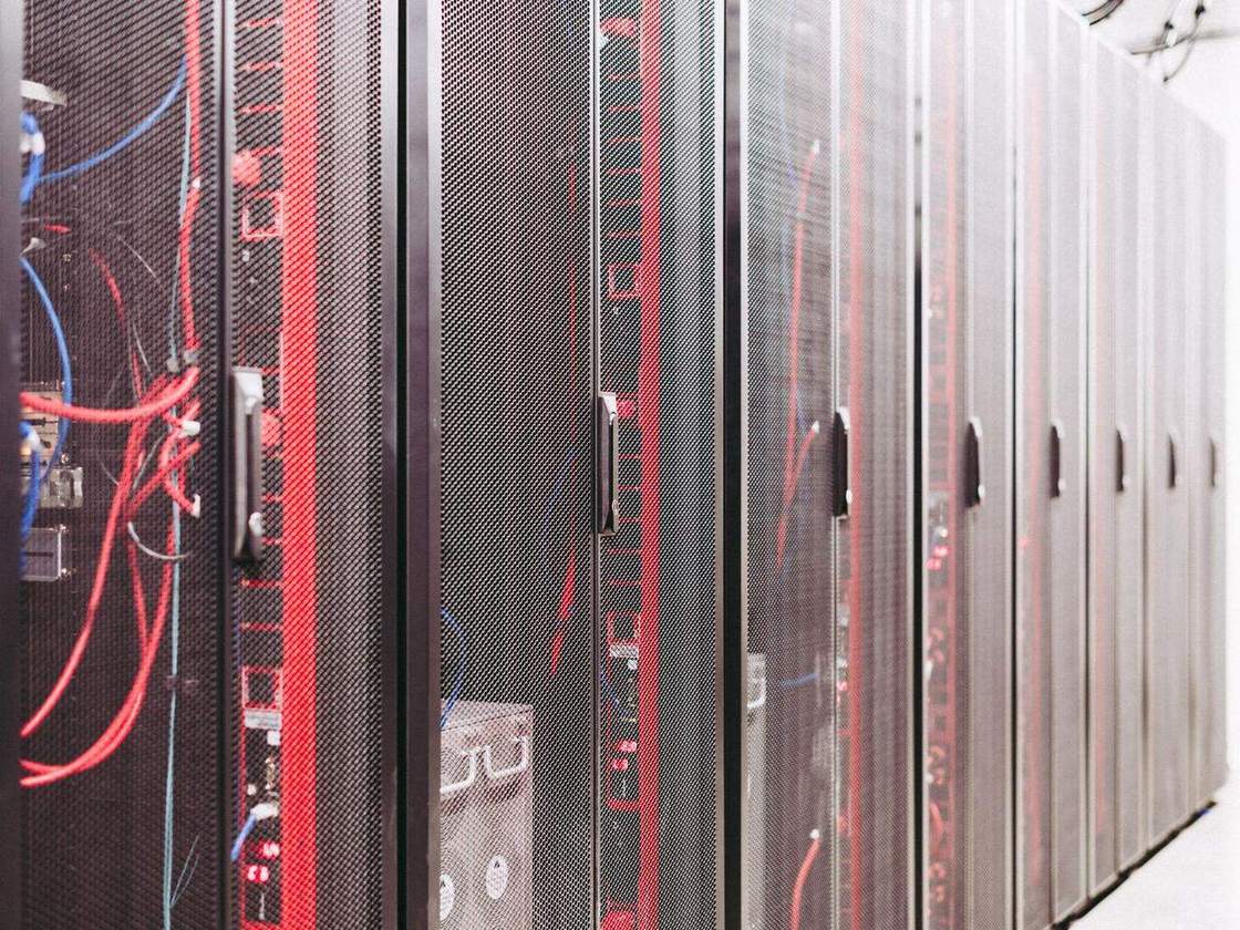 Rows of server racks with network cabling in a data center