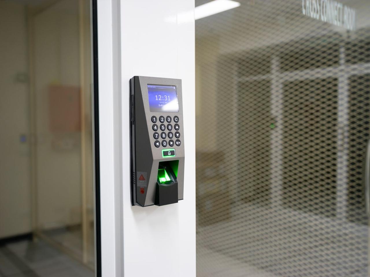 A fingerprint access reader mounted beside a secure door